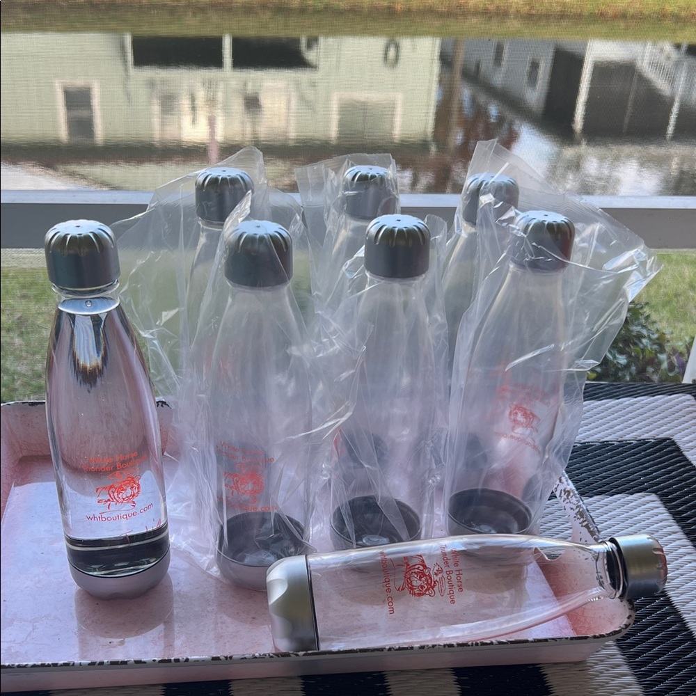 # 0827+ 8 Of Silver and Clear Refilled Plastic Water Bottles